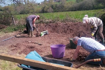 The Eager Beavers digging up soil for the community garden.