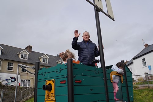 Beer and Branscombe Councillor John Heath at the Beer Jubilee Play Park with children from Puffins Nursery, March 2024