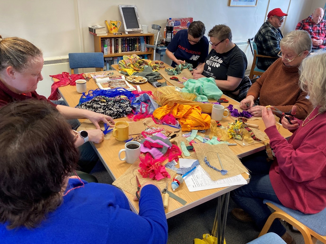a group of people creating crafts in a community hub