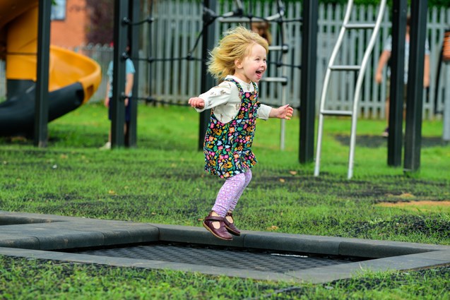 Elsa Fitzgerald jumping on a ground level trampoline at Budleigh Salterton's Greenway playground